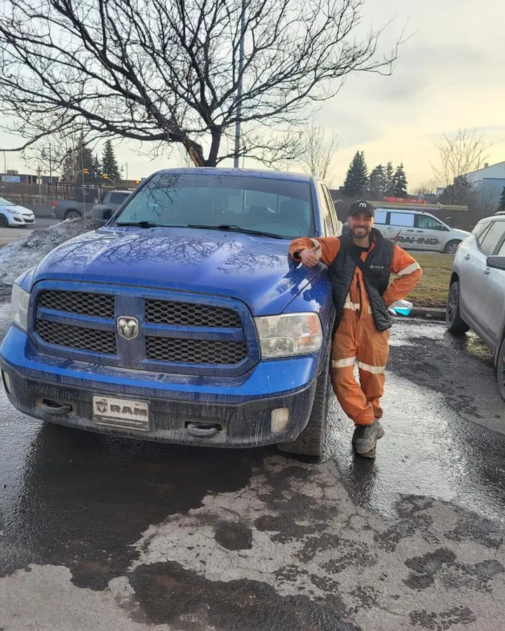 Client devant son Ram 1500 bleu vendu à En Ligne Autos